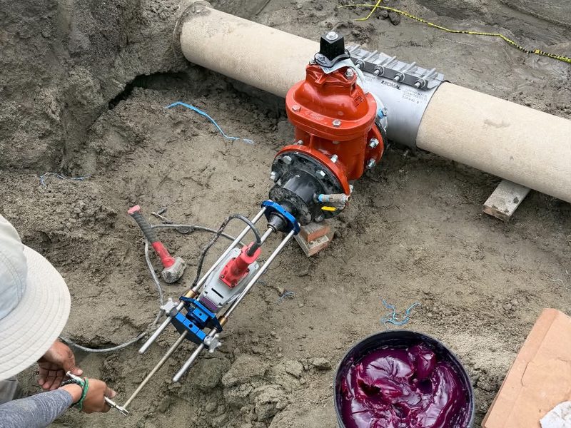 Tapping machine mounted for a live water main connection