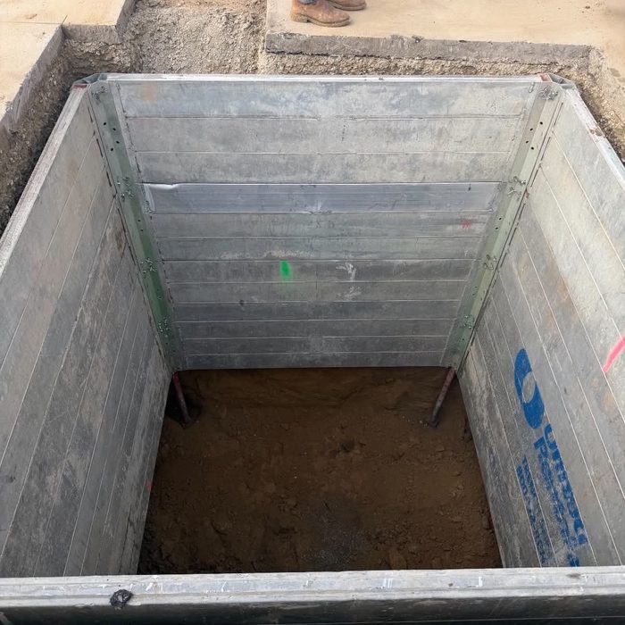 Cast-in-place concrete utility vault set in the ground